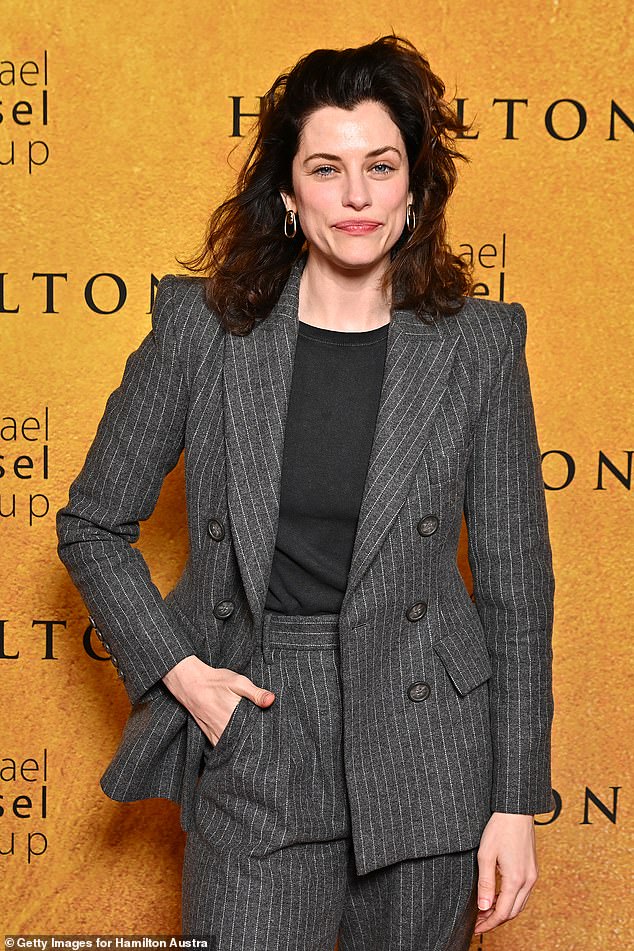 Jessica De Gouw exuded timeless elegance in a custom-made gray pinstripe suit