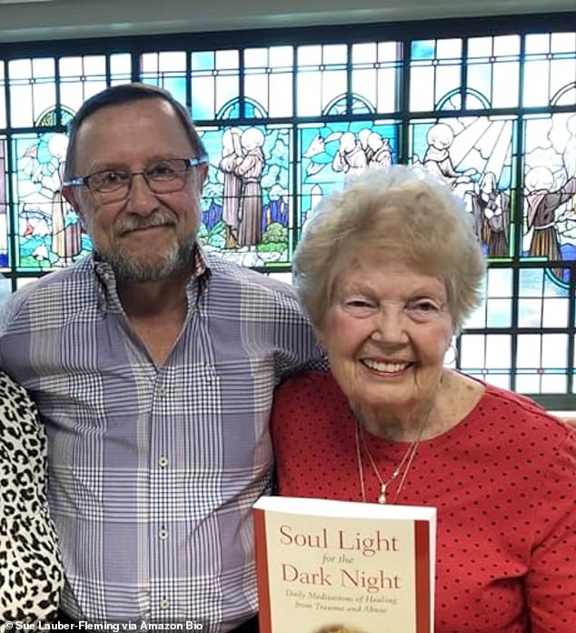 Mrs. Fleming [right] has not yet recovered, has taken the joy out of their lives and damaged their marriage. They are pictured above with a book the couple wrote about how to heal past abuse trauma