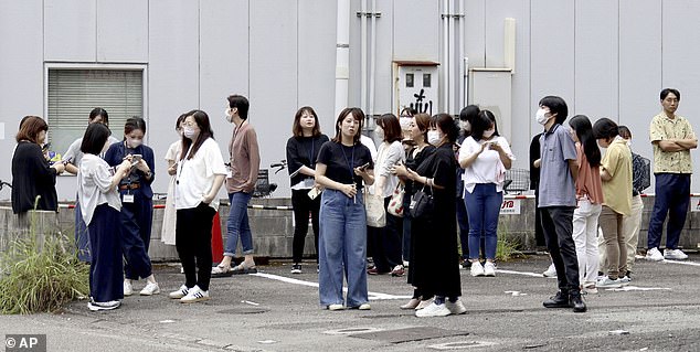 People seek shelter outside after the quake. The Japan Meteorological Agency has issued a tsunami warning after the powerful quake