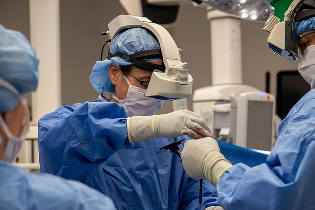 The headset allows surgeons to see the real world, but with virtual screens in front of them displaying important information, also known as augmented reality.