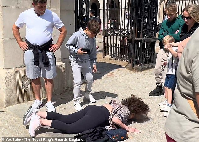 Another woman was reportedly thrown onto the sidewalk by one of the Royal Guard's horses