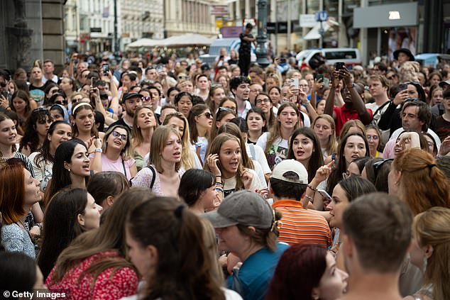 Taylor Swift fans sing together at Stephansplatz on August 8, 2024 in Vienna, Austria