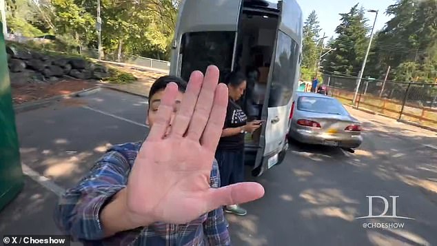 At one point, one of the emergency workers was seen trying to cover Choe's camera and push him away from the van