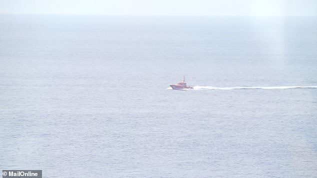 Spanish authorities came to rescue the stranded small boat carrying people and waved for help