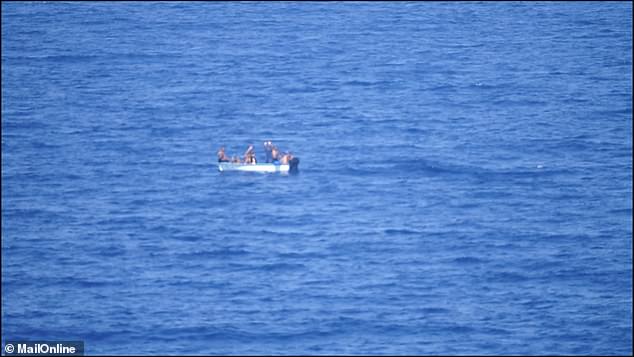 The cruise ship's captain alerted Spanish authorities, who then guided the small boat (pictured) carrying about eight people to shore at around 4:30 p.m. local time.