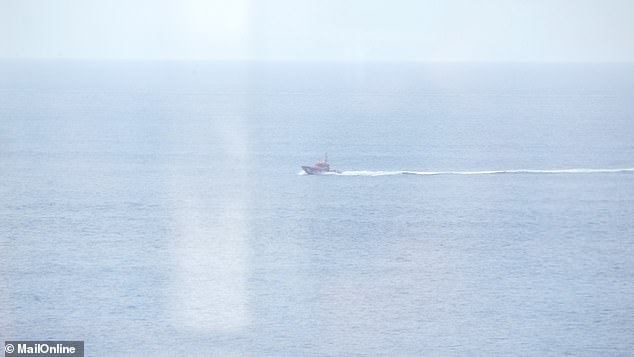 Pictured: The Spanish coast guard on its way to rescue the small boat