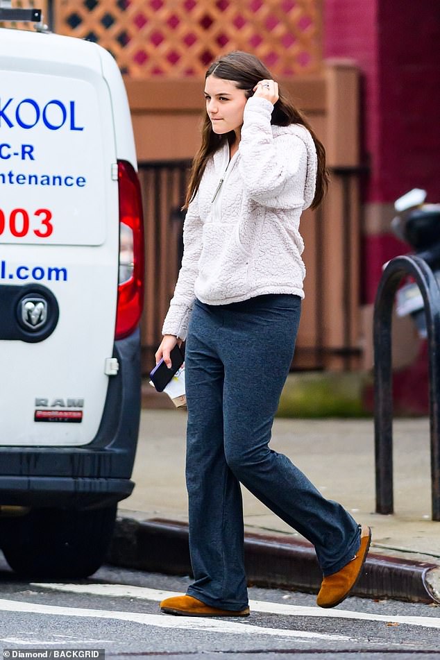 Tom Cruise and Dawson's Creek star Katie's 18-year-old daughter wore a comfy teddy hoodie and blue sweatpants as she went grocery shopping