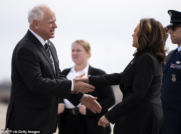 Minnesota Governor Tim Walz (left) greets U.S. Vice President Kamala Harris upon her arrival at Minneapolis-St. Paul International Airport