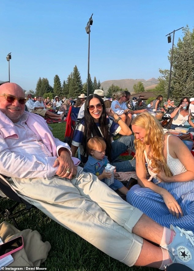 Bruce Willis was pictured relaxing in a lawn chair with his ex-wife and daughters surrounding him