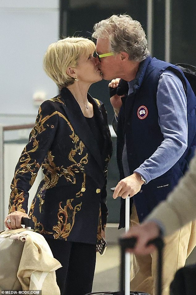 Ms Bishop, who was Australia's Foreign Minister from 2013 to 2018, kissed the Perth man as they stood with their luggage at the Qantas counter