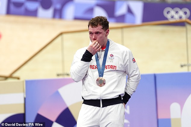 Both countries have an equal number of gold and silver medals, but Team GB are one bronze medal ahead and will have to fight to maintain that lead (pictured - Jack Carlin after winning bronze in the men's sprint final) |