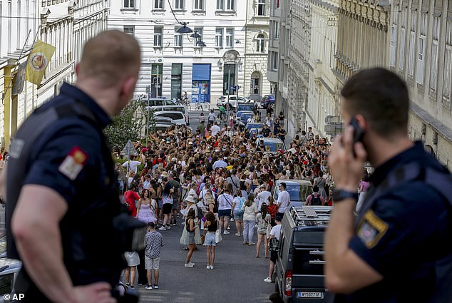 Police can be seen watching as the rally takes place in the city centre