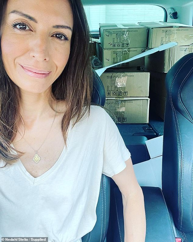 The mother of two pictured with a car full of boxes of her products