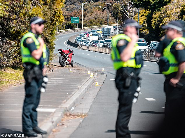 Officers have revealed a significant spike in the number of motorcyclists and pedestrians killed (pictured: police at the scene of a motorcycle crash in 2022)