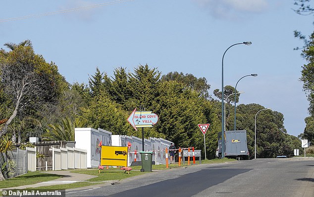 A sign outside the construction site reads 'Island Cove Villa' before a long driveway leads to the heart of the complex, surrounded on all sides by identical homes