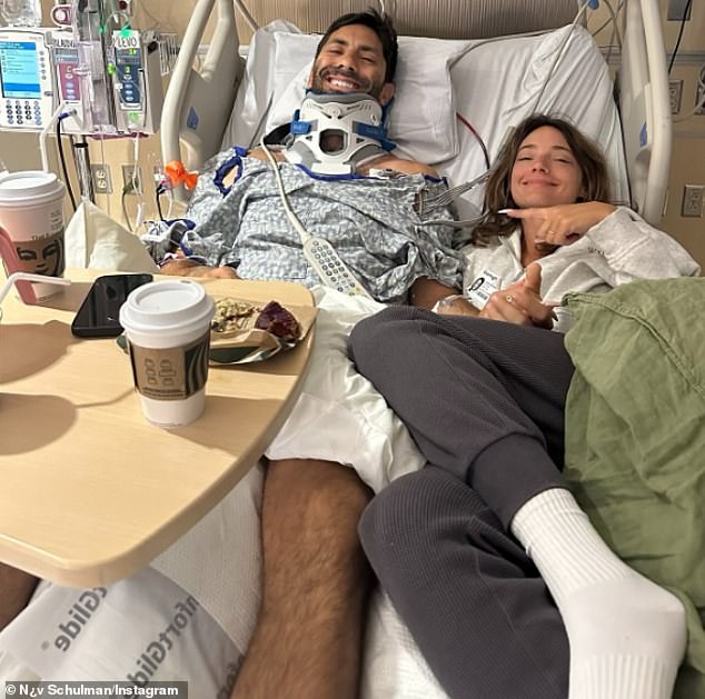 One photo shows his wife Laura Perlongo lying next to him in bed as the two smiled bravely for the camera.