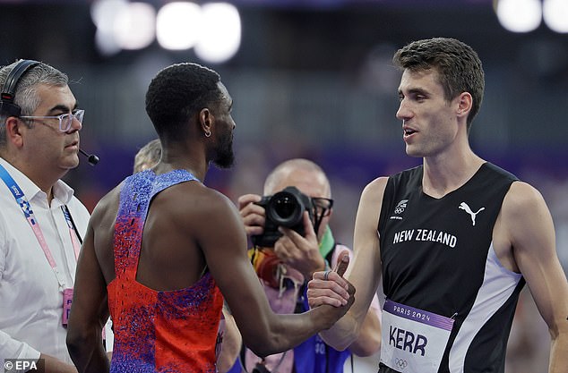 Second-place finisher Shelby McEwen of the US (left) shakes hands with first-place finisher Hamish Kerr of New Zealand (right) after the men's high jump final