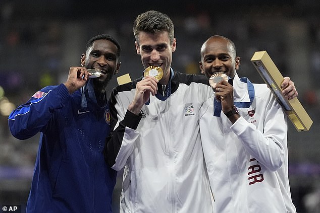 Qatar's Mutaz Barshim (right) took a bronze victory Shelby McEwen (left) won silver