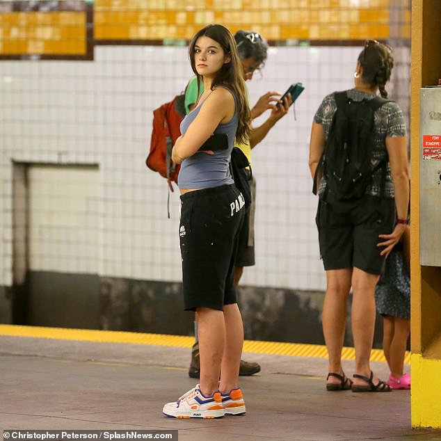 Suri enjoyed a brief respite from the summer sun as she waited to board the subway