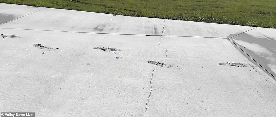 Footprints can be seen in the concrete driveway from when workers walked over it before it dried