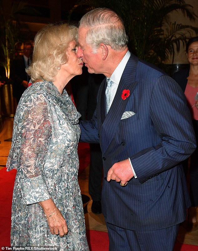 King of romance! Charles greets Camilla with a tender kiss during a visit to Merlion Park in Singapore in 2017. It was at the start of their 11-day trip to Southeast Asia and India and the couple had not seen each other for a few days