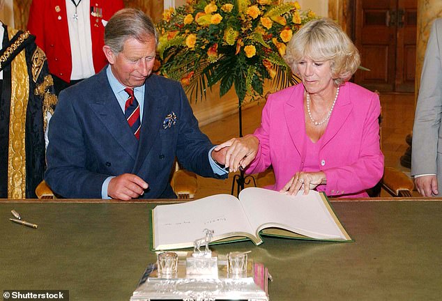 Camilla gently places her hand on Charles's at a reception to mark Cardiff's 50th anniversary as a capital and centenary as a city, July 2005. The ceremony took place just three months after the couple were married.