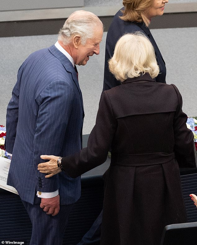 Camilla places a loving hand on Charles' arm in the Bundestag in Berlin during their state visit to Germany, March 2023. They traveled to Berlin, Brandenburg and Hamburg over the three days