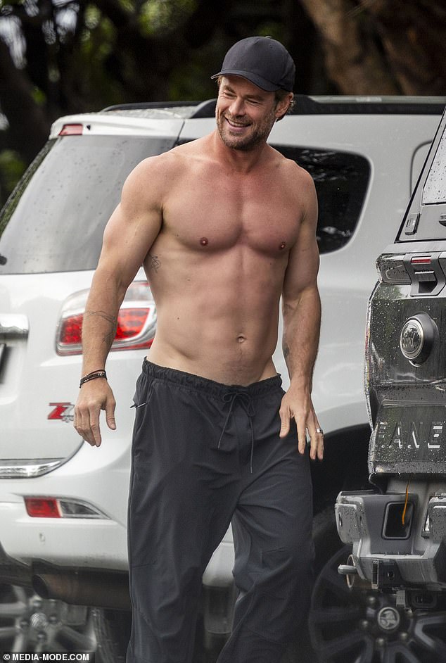 The star donned loose black pants but was shirtless as he mounted his surfboard to his car