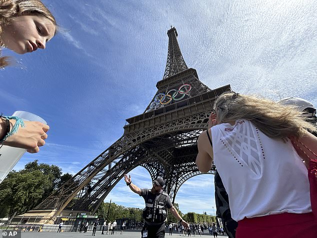 Police clear area around Eiffel Tower after man spotted climbing historic landmark