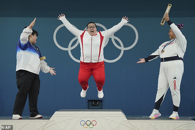 The medal winners were all smiles on the podium as Li celebrated winning gold in Paris