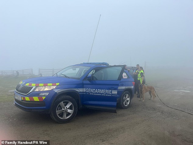 Searches in the region are being hampered by poor visibility (pictured: gendarmes with a dog in the area)