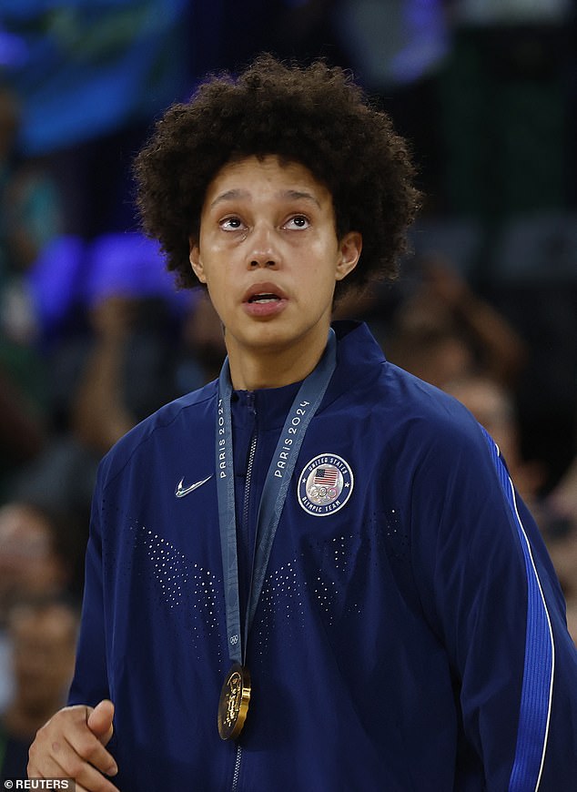 American gold medalist Brittney Griner begins to cry on stage during the national anthem