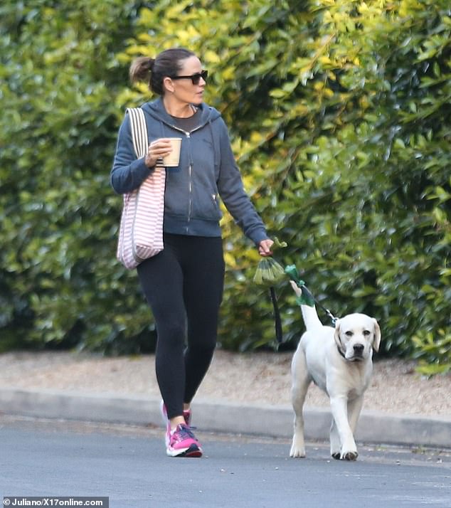 She kept it casual in a navy jacket and black tee and added a touch of comfort with leggings