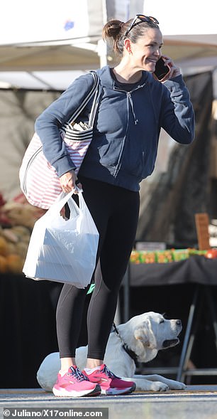 The Deadpool & Wolverine star slung a striped bag over her shoulder and carried a cup of coffee as she went shopping