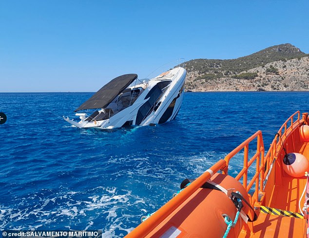 Images released by the Majorca coastguard show the yacht, valued at a staggering £800,000, lying on its stern with the bow of the vessel sticking out of the water and pieces of rubbish floating in the water next to the distressed vessel.