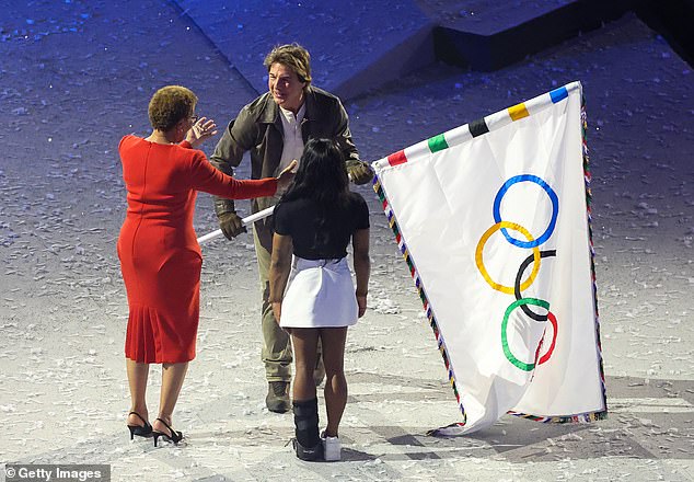 Tom was later presented with the five rings of the Olympic flag by gymnast Simone Biles and the mayor of LA