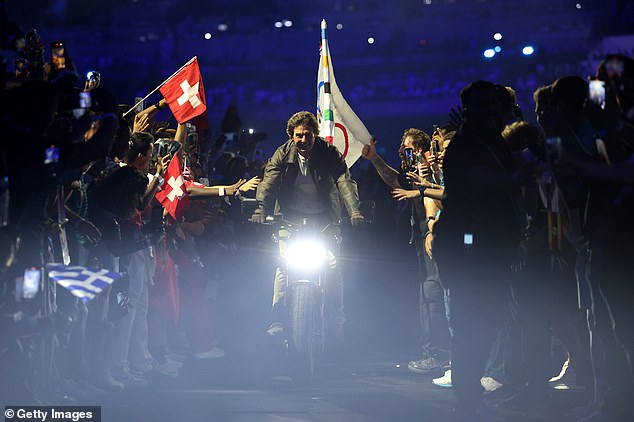 He loaded the flag onto the back of a waiting motorcycle and rode out of the stadium standing