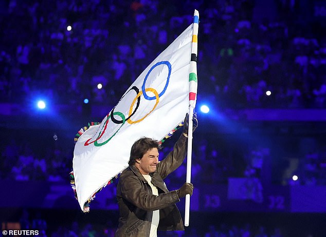 The actor held the Olympic flag during the dramatic closing ceremony in Paris