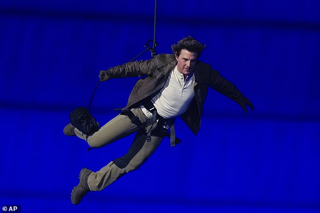 Action star Tom Cruise kicked off the Olympic handover by jumping off the roof of the Stade de France in a death-defying stunt