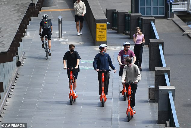 A man running for mayor in the next election said he would let e-scooters stay but would reduce their speed to 12km/h (pictured men on e-scooters in Melbourne)