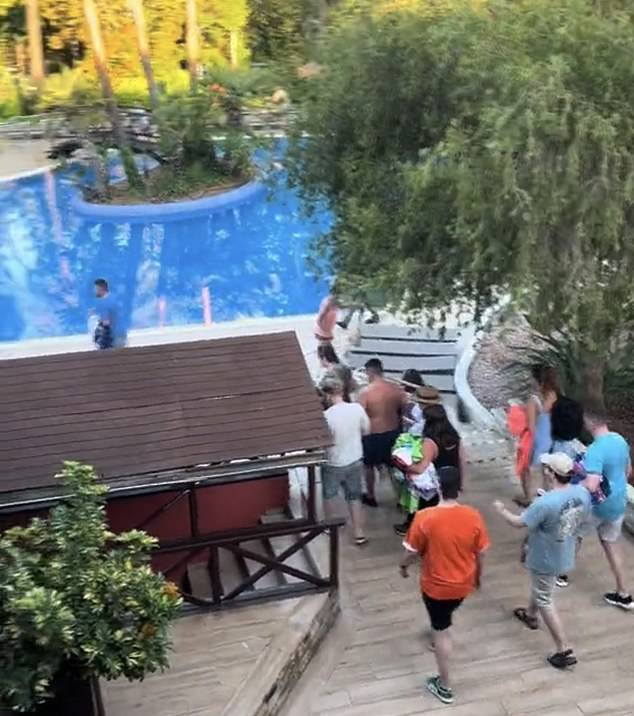 A separate video shows the Brits running past each other and pushing on the edge of the pool as they try to get the best spots