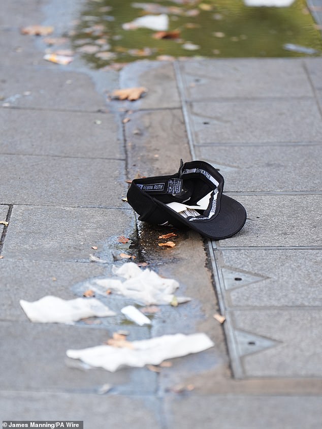 A baseball cap at the crime scene in Leicester Square, London, where a man was arrested after an 11-year-old girl and a 34-year-old woman were stabbed