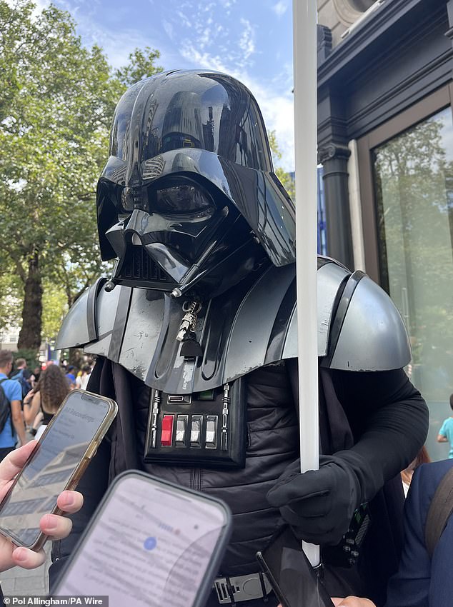 Desmond, 45, (pictured), who performs as Darth Vader on the square 'every day', told reporters: 'When I looked over I saw a young man... stabbing her multiple times [times] with a knife