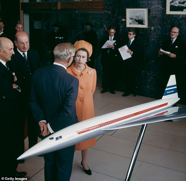 Queen Elizabeth II talks to businessmen in front of a model of the Concorde aircraft, at the British Aircraft Corporation factory in Filton, Bristol, September 1966.