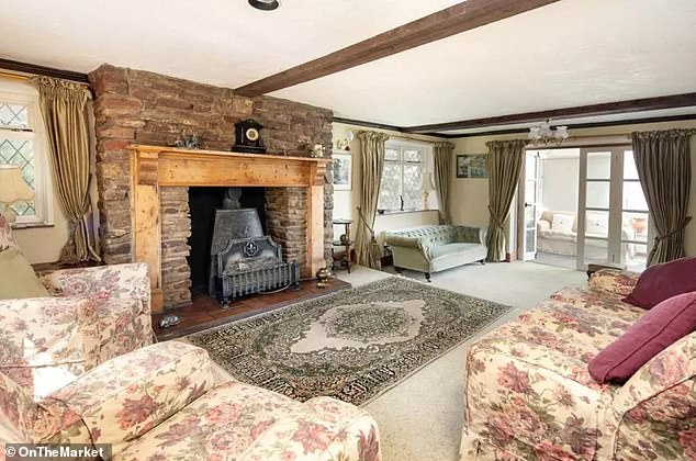 The beautiful period property, described as a 'coastal treasure', dates back to the late 19th century and includes exposed ceiling beams (seen in the sitting room) as one of its period features