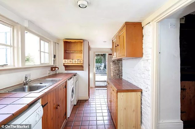 The utility room of the house leads to a small terrace and lawn