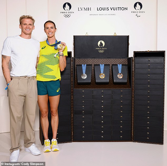 Simpson, 27, who nearly qualified for the Games herself, took to Instagram on Tuesday to cheer on Emma's success. Cody shared a photo of himself next to his beloved as she held up her gold medal next to a display case of her other medals from the 2024 Games