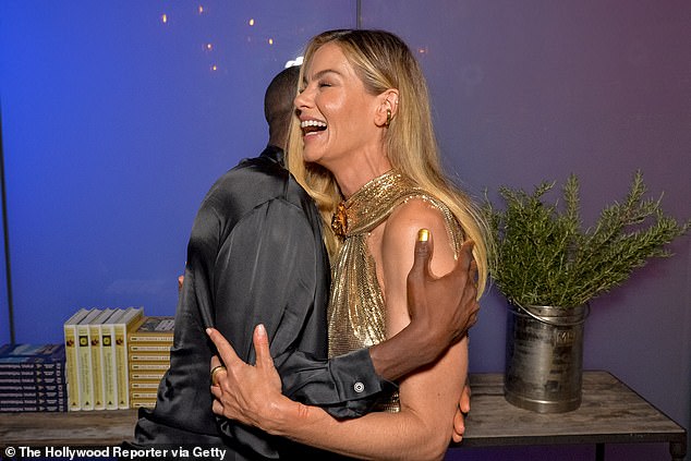 The Best Of Me star couldn't contain her smile as she hugged actor Ronald Peet, who was wearing a black satin shirt