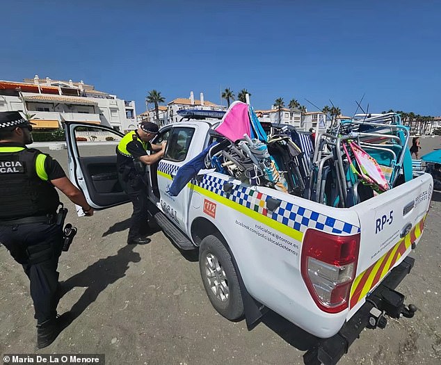 The photo shows a police car loaded with confiscated chairs and umbrellas