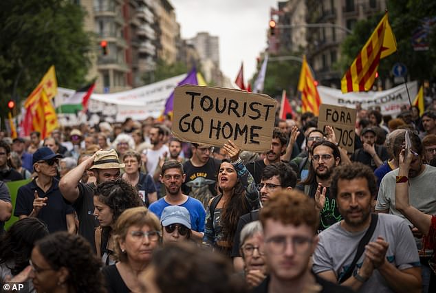 Protesters march in the centre of Barcelona last week, chanting slogans against the Formula 1 Barcelona Fan Festival